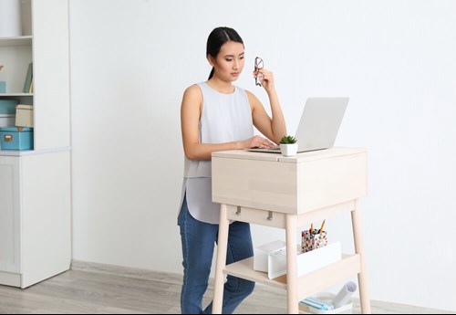 women standing up whilst working from home 