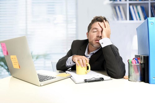 employee being very lazy and sleeping at his desk 