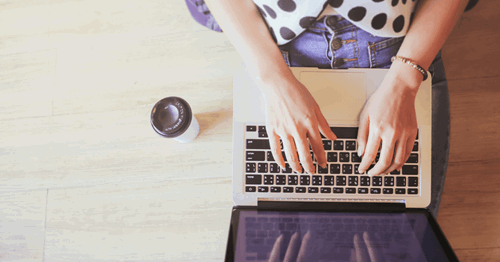 writing on laptop keyboard 