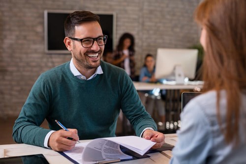 man looking happy and smiling whilst in interview 