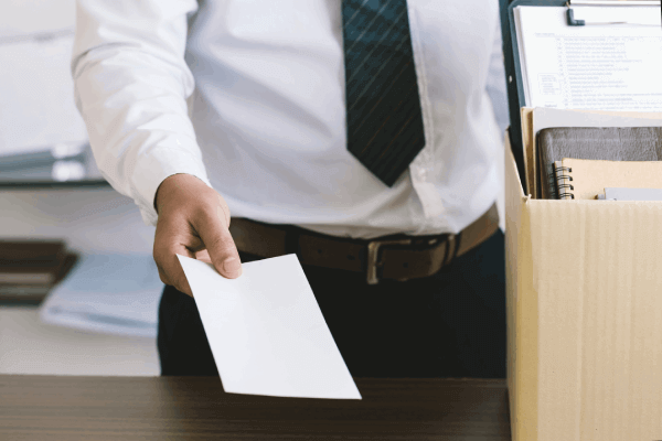 Man placing paper on a desk