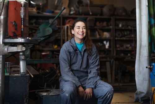 women wearing overalls in a engineering setting 