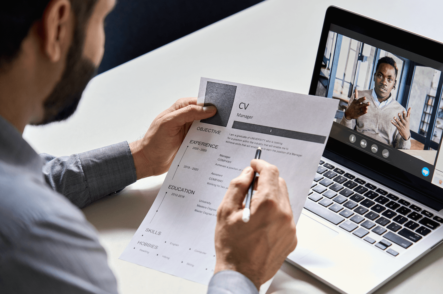 Interviewer looking over a CV whilst on a virtual interview call